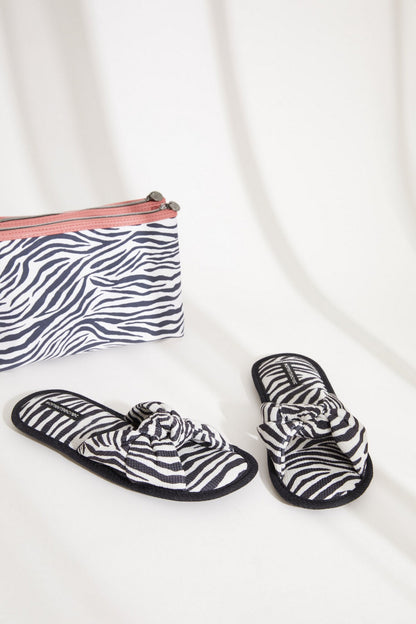 Zebra-print slip-on slippers with knotted straps, plus matching zip pouch