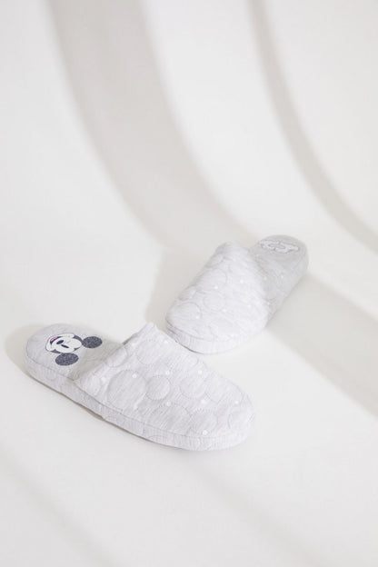 Light grey quilted mule slippers with blue cartoon mouse paw patch and cushioned sole