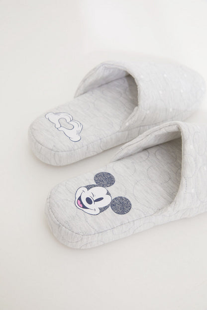 Light grey quilted slip-on slippers with blue cartoon mouse face patches