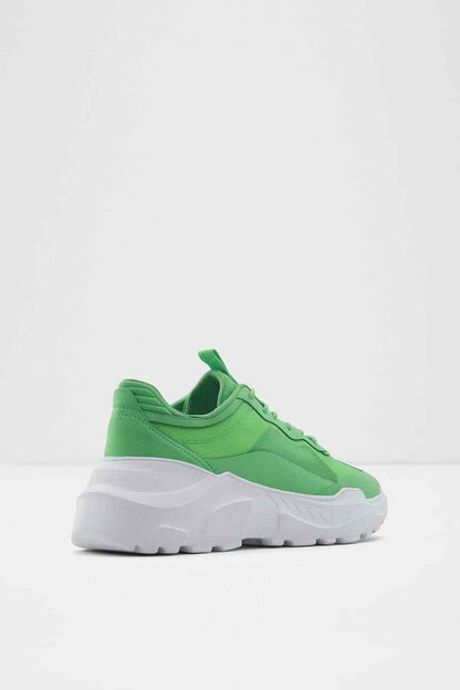 Green lace-up sneaker with sculpted white sole, side view