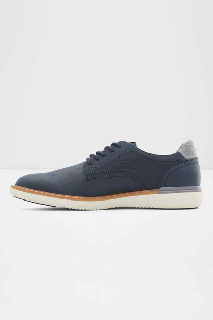 ALDO navy lace-up low-top sneaker, front 3/4 view, tan sole edge and white sole