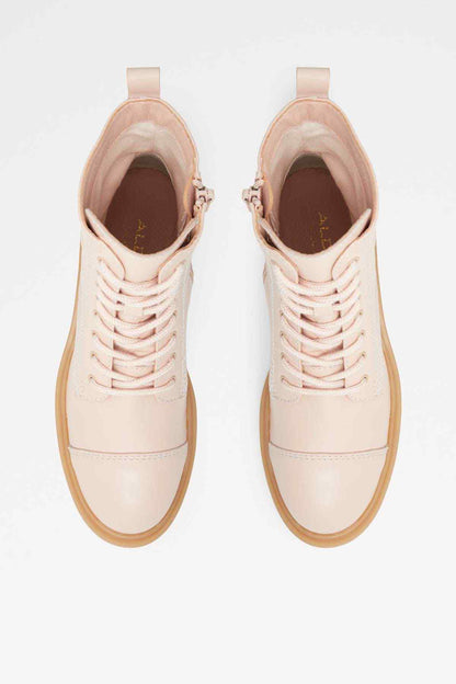 Pair of natural beige lace-up ankle boots with tan interior lining
