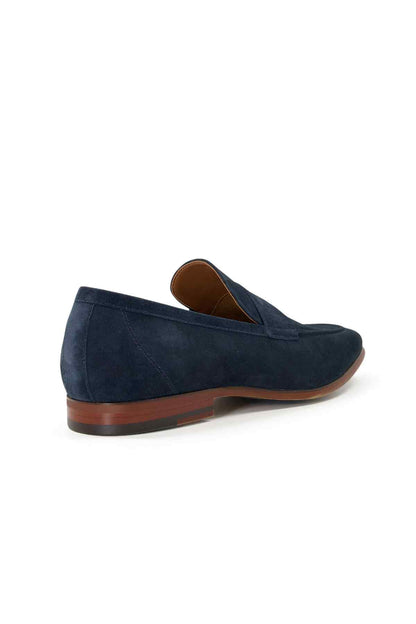 Navy suede loafer side view, brown outsole and cushioned footbed