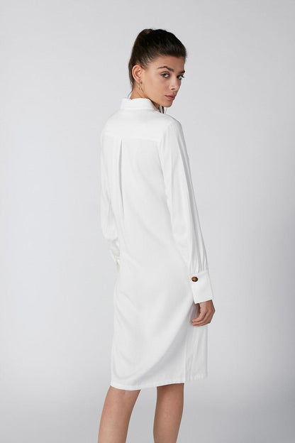 White long-sleeve shirt dress, high neckline, back view with belt tie and cuff buttons