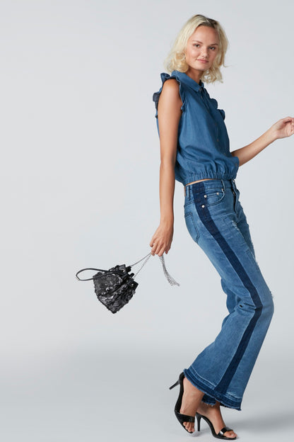 Blue sleeveless denim top with ruffle shoulder detail and button-front