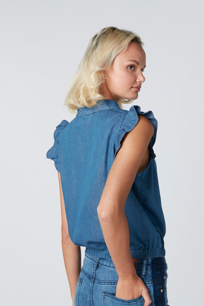 Blue sleeveless denim top, back view, ruffled shoulders and button closure
