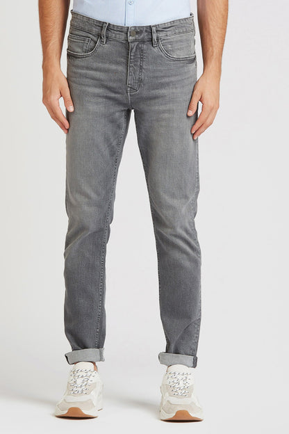 Grey denim jeans front view with button fly, belt loops, five-pocket design