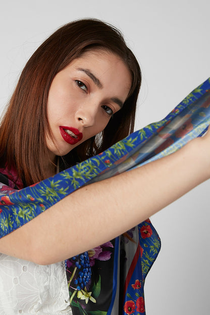 Multicolor floral scarf draped over arm, blue and red pattern
