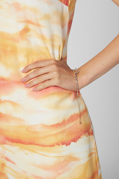 Gold-tone charm bracelet with oval center stone and dangling chain
