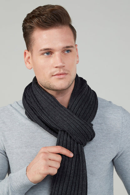 Ribbed knit infinity scarf in dark charcoal worn by a model