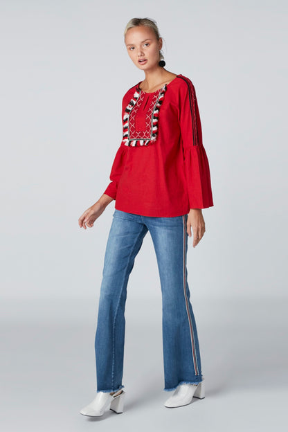Red long-sleeve tunic with decorative front yoke and flared sleeves