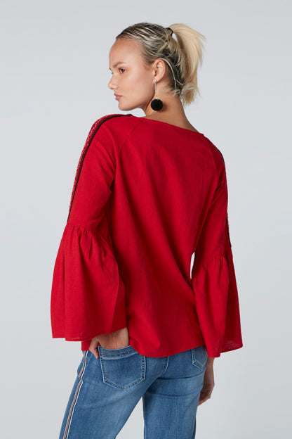 Red long-sleeve tunic with draped back and flared cuffs