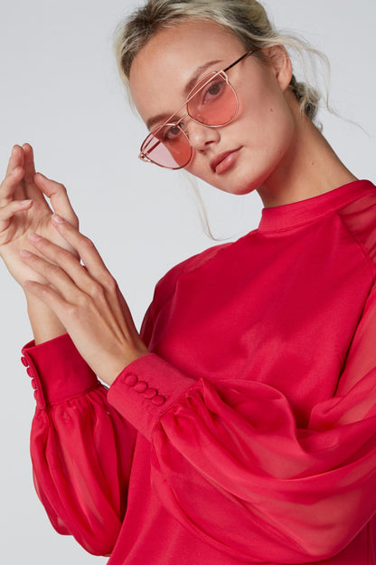 Red long-sleeve blouse with gathered cuffs and loose fit