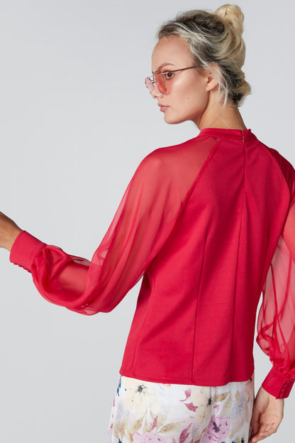 Red long-sleeve blouse back view with gathered cuffs