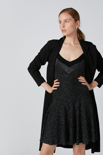 Black sleeveless V-neck flared dress with open-front black cardigan