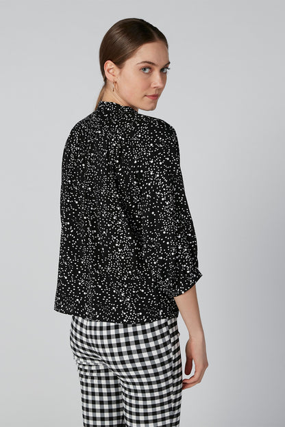 Black speckle blouse with stand collar and 3/4 sleeves, side/back view