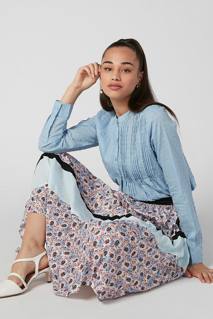 Light blue long-sleeve dress with pintuck pleats and floral contrast hem lining