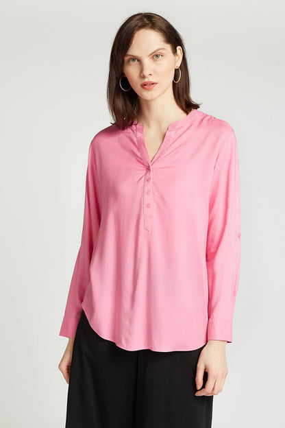 Pink button-front blouse with V-neck, long sleeves, and front pleat