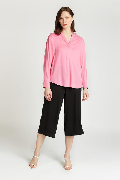 Pink button-front blouse with split V-neck and long sleeves, relaxed fit