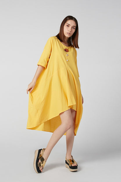 Yellow asymmetrical tunic dress with short sleeves and scoop neckline, draped hem