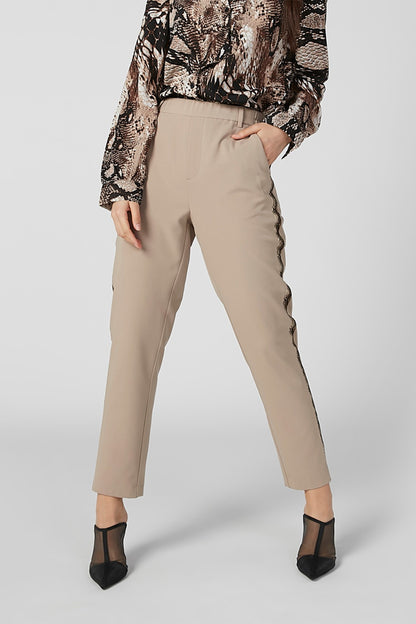 Beige tailored pants with belt loops, zip fly, and cuffed ankle hem