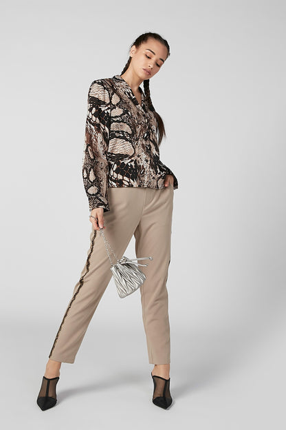 Beige ankle pants with belt loops and side pockets, tapered leg