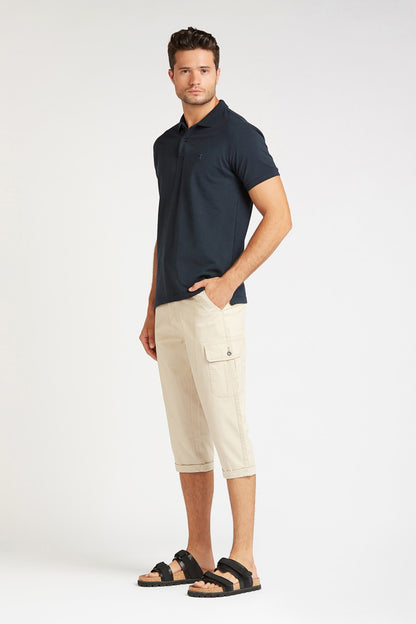 Beige cargo capri shorts with front button closure and side flap pockets