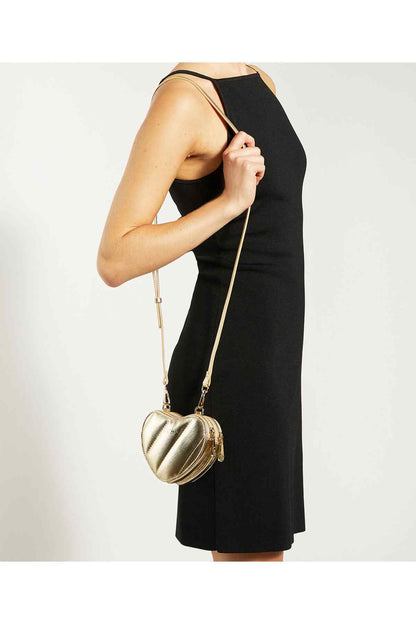 Gold heart crossbody bag with chain strap, worn crossbody.