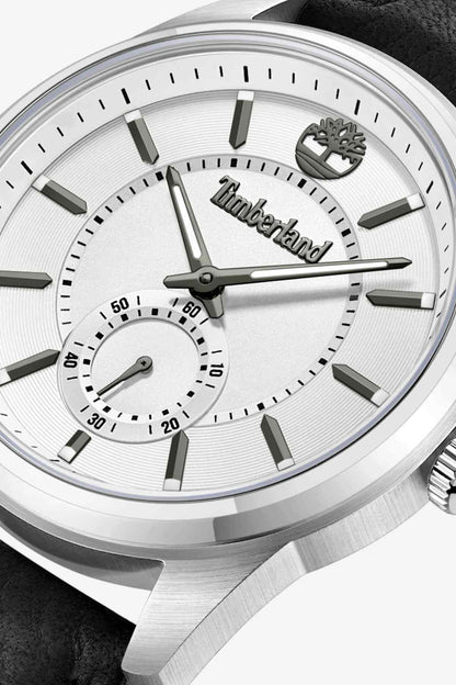 Timberland watch close-up: white dial with Timberland hands and markers, silver bezel.