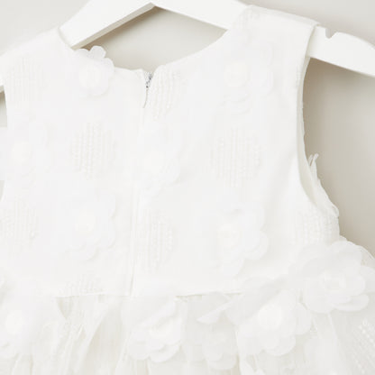 White sleeveless baby dress with front zip and 3D petal ruffle detail at hem