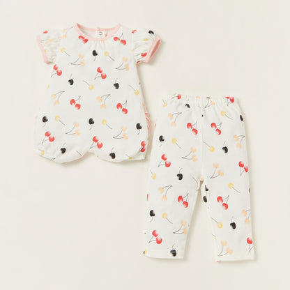 Baby short-sleeve romper and pants set with cherry print, pink trim, and cuffs