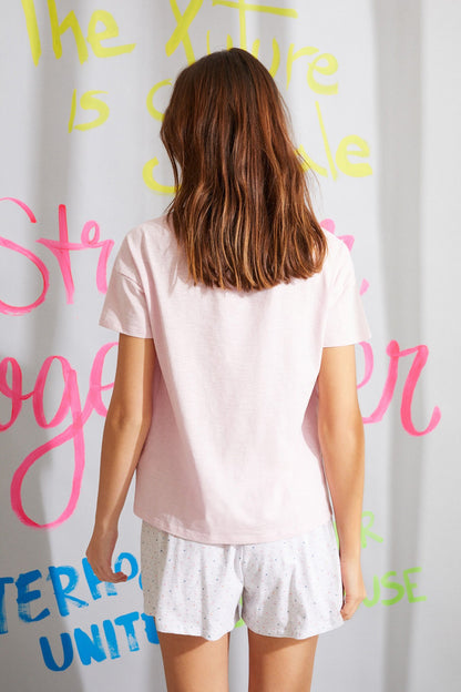 Light pink short-sleeve T-shirt and patterned sleep shorts, back view