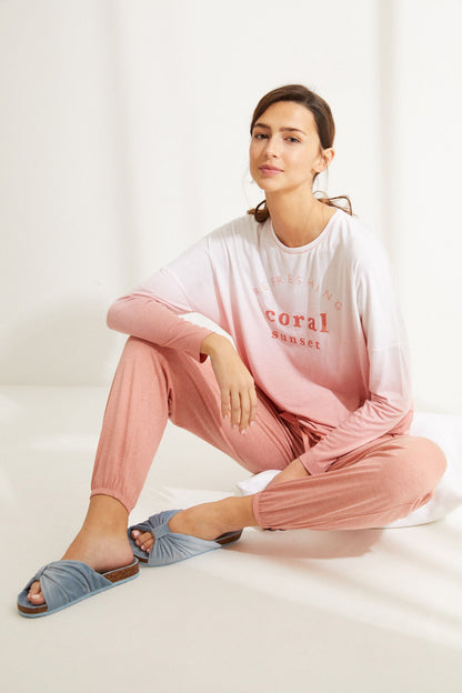 Women's pink long-sleeve lounge top and matching pants, relaxed fit.