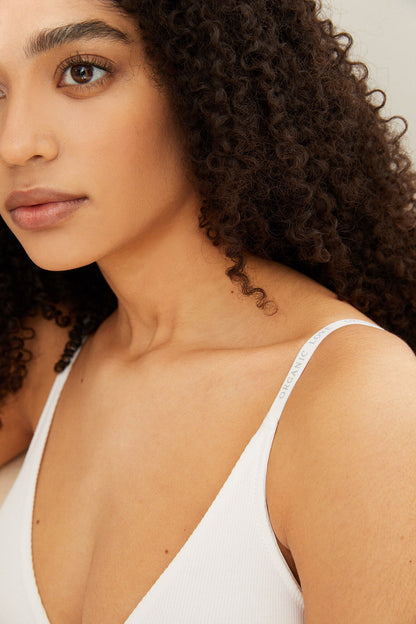 Ivory V-neck bra top with smooth cups and thin logo-edged straps