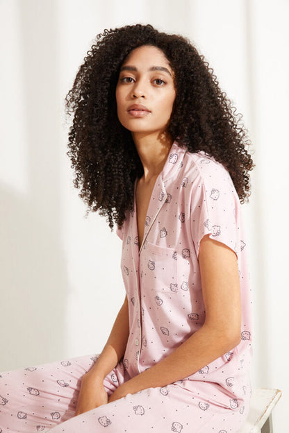 Pink pajama pants and short-sleeve top set with cartoon icons