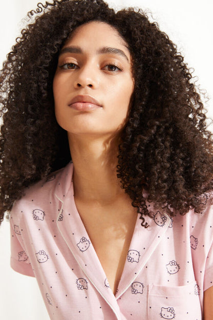 Pink pajama top with short sleeves, V-neck button style, cute print