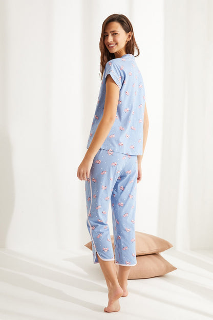 Light blue pajama set with button-front top and cropped pants, multicolor print