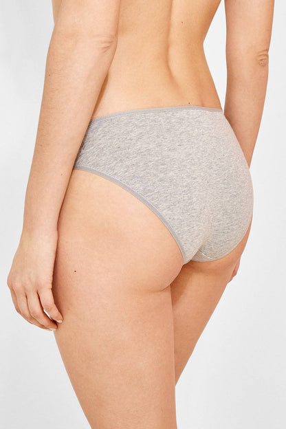 Grey hipster briefs on model, mid-rise with elastic waistband and smooth knit