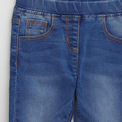 Blue denim jeans for baby close-up of front pockets with orange contrast stitching