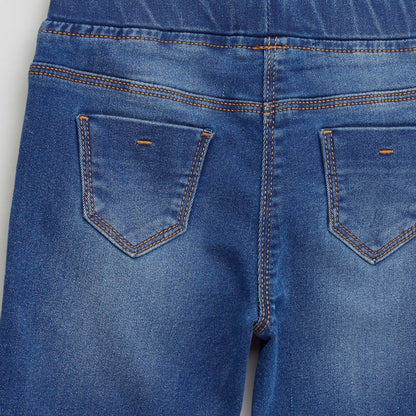 Blue denim jeans for baby close-up of front pockets and waistband seam details